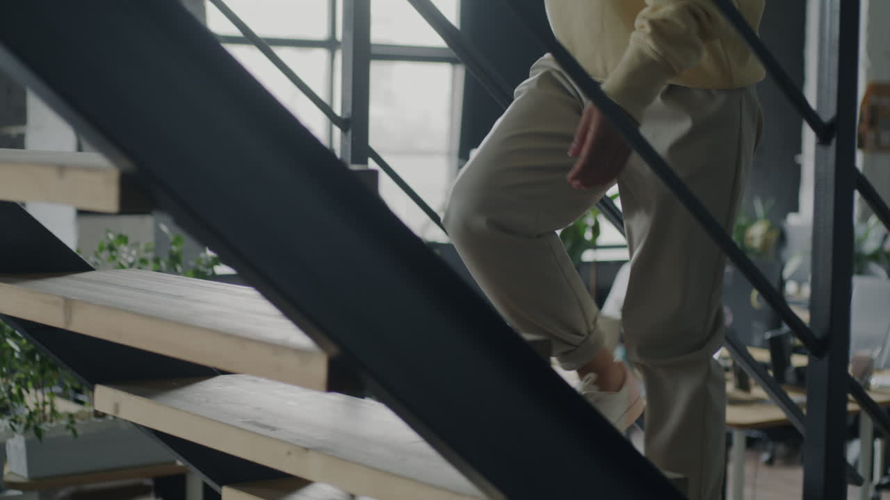 Woman walking up the stairs in a modern office
