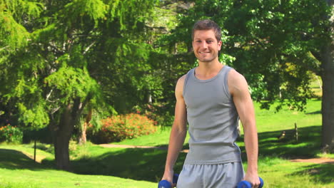 young man using dumbells