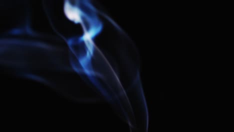 abstract blue color smoke with a black background in slow motion