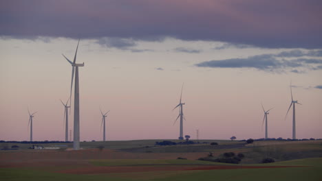 numerous windmills working in field