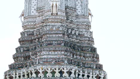close-up view of wat arun's ornate spire showcasing detailed craftsmanship and decorative elements.