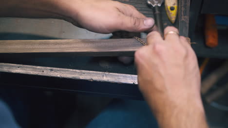 jeweler installs chain on gutter to polish on table closeup