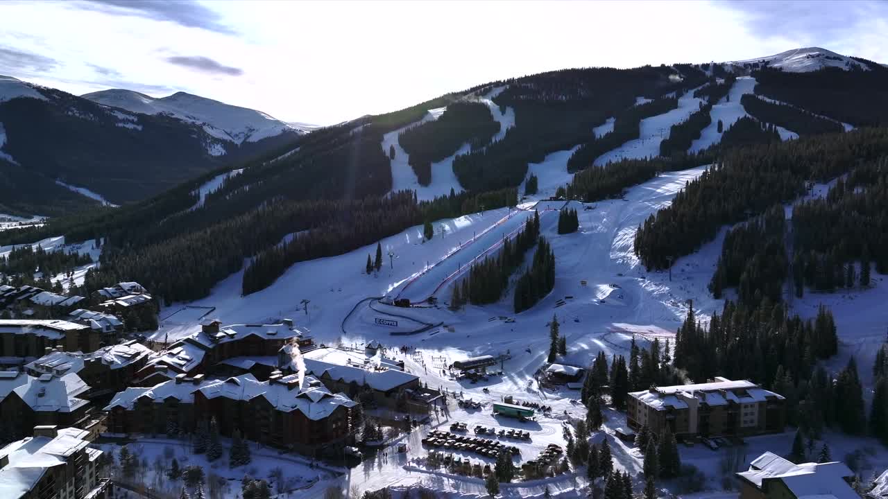Morning sunrise winter solstice Copper Mountain Resort aerial drone Center village chairlifts gondola Ikon Pass Alterra snowboarding snow ski riding trails December halfpipe trees backwards motion