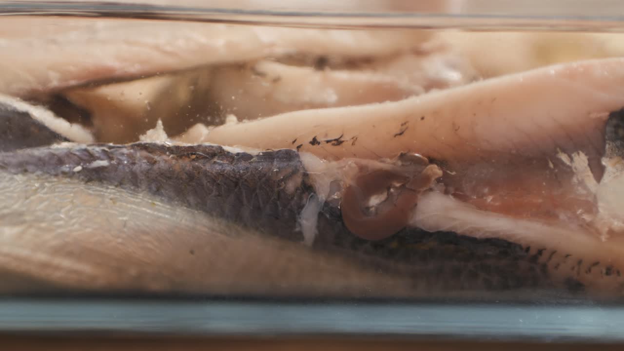 Fresh Sea sardines and Anchovy Fish and Mullus On Display On Ice On Market Store Shop. Seafood Fish Background, close up stand of small salty white fish.