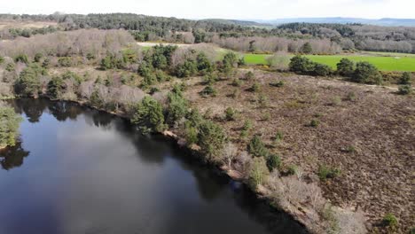 Aerial-View-Over-Squabmoor-Reservoir-Located-In-Woodbury-Common,-Devon