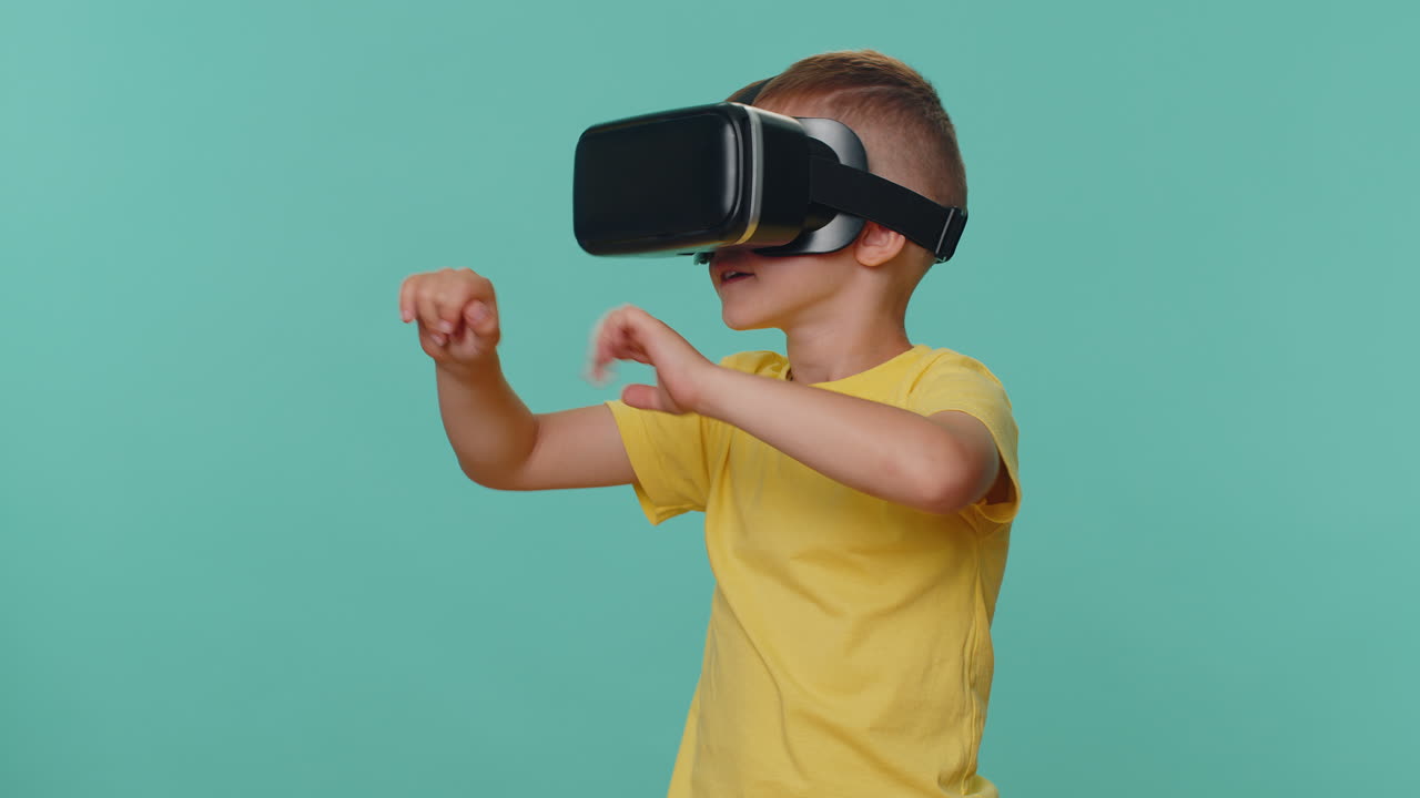 Little toddler children boy using VR headset helmet app to play simulation virtual reality game
