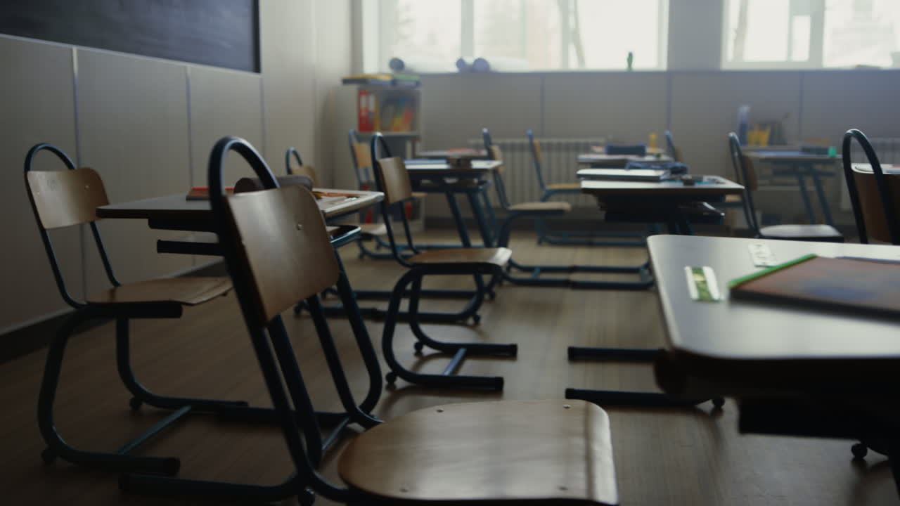 Empty school room. Interior of classroom with desks and chairs for education