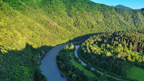 ruins overlook river in green valley. historical ruins nestled in a lush valley, surrounded by trees, overlooking a winding river in sunlight