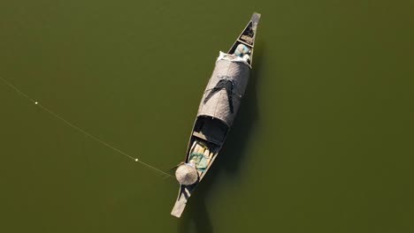 fisher man net fishing in river of surma, bangladesh, aerial top down view