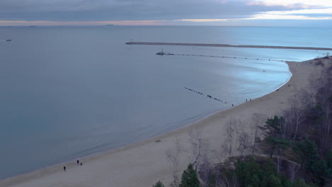 aerial view of calm sea, stogi nudist beach and seawall in sunrise in gdansk, poland