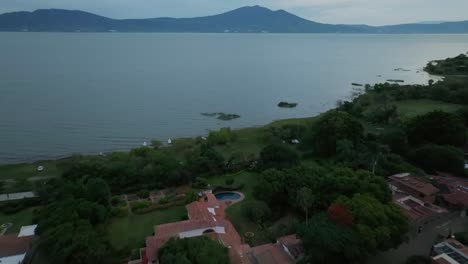 mountains and lake chapala in mexico at dusk - aerial dolly in shot