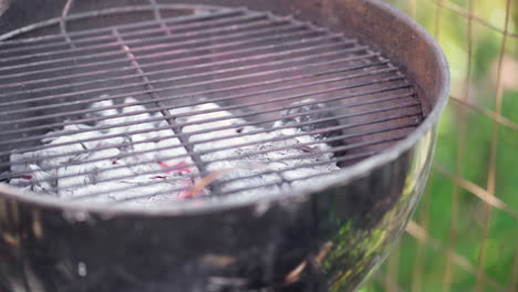 slow motion of empty smokey bbq grill with coals