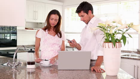 Pretty-woman-making-her-husband-a-coffee-in-the-morning