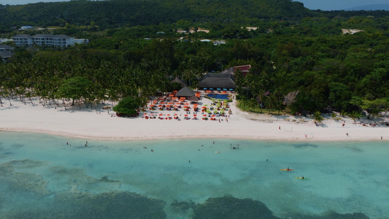 Aerial view of tropical coastline with white sand beach and palm trees Panglao Bohol Philippines drone
