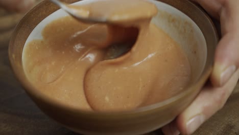 Mixing-cheeseburger-sauce-in-small-bowl-by-hand-with-spoon