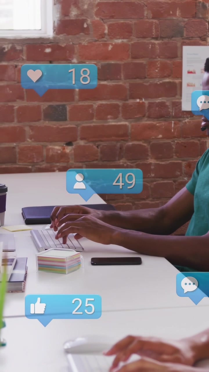 Diverse coworkers at desk tracking likes with bubbles rising while man typing on keys, copy space