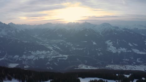 sunset in austrian alps, aerial drone footage of ski resort patscherkofel, pull back movement