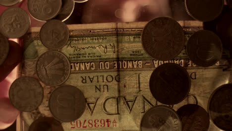 collection of vintage coins and a canadian dollar bill