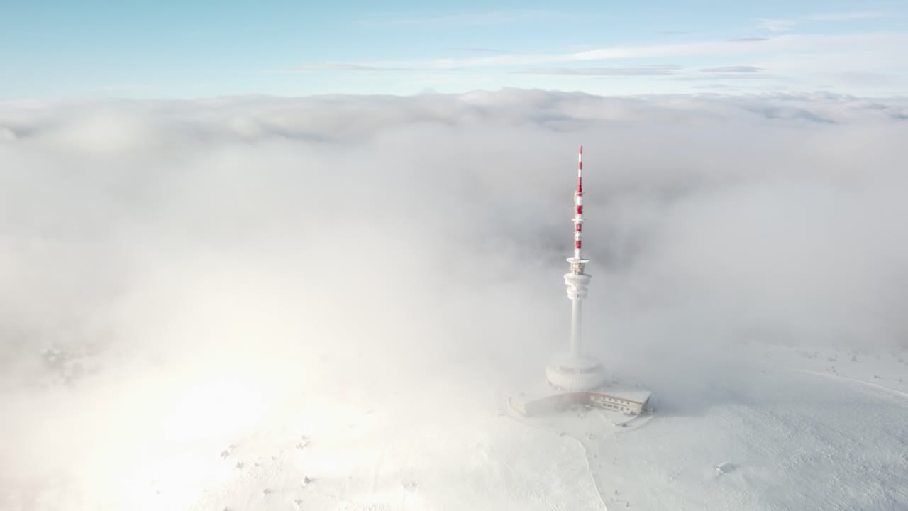 Transmission And Lookout Tower Covered With Clouds And Fog In The Praded Mountain Peak In Czech Republic. - aerial shot