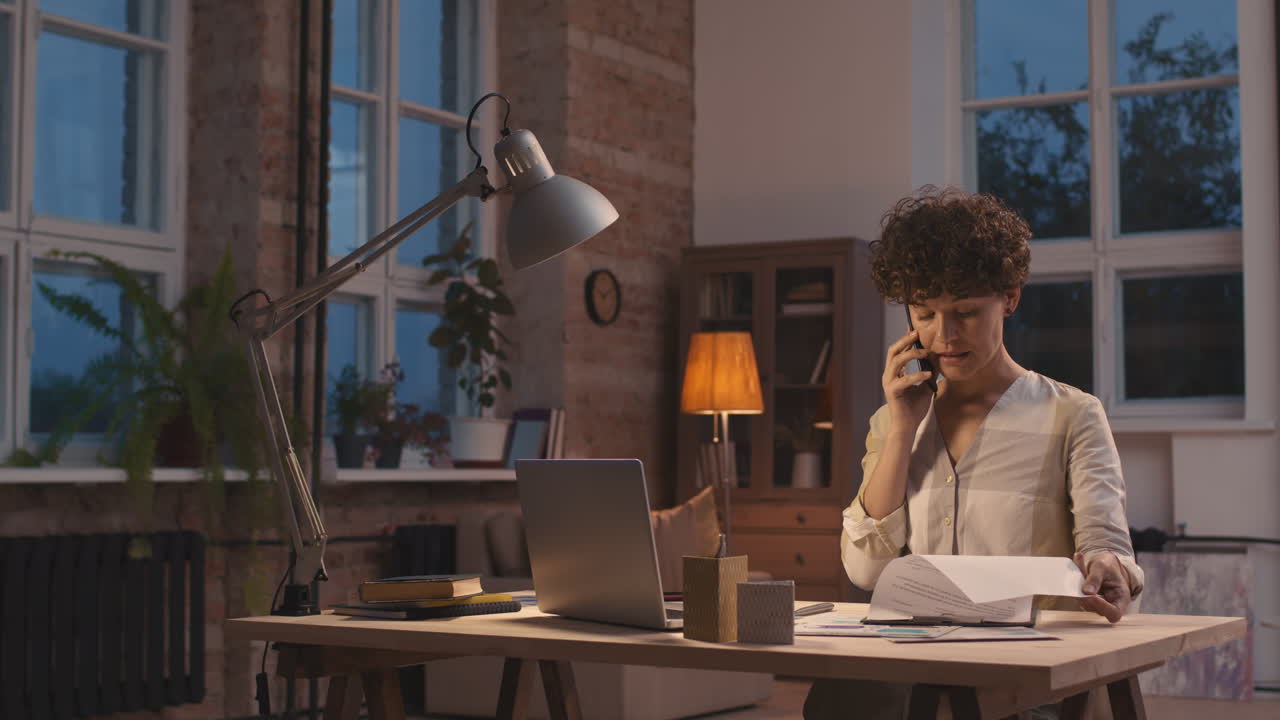 Woman working late at home office
