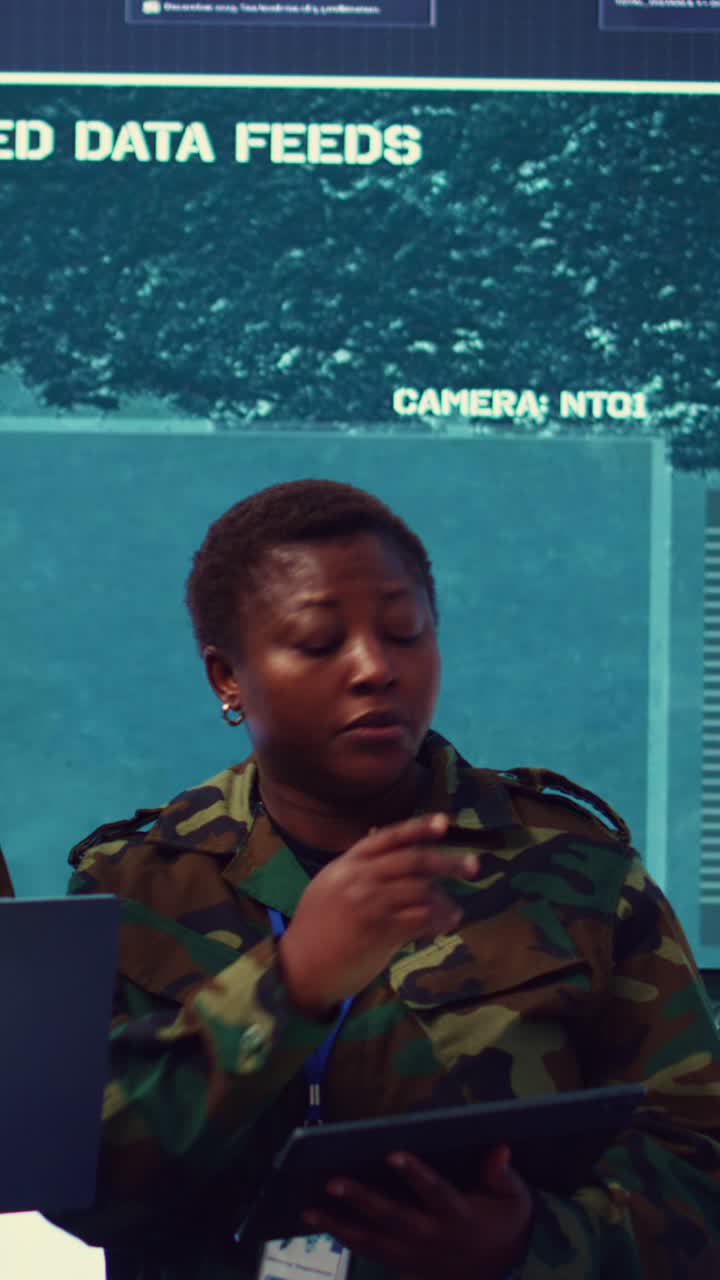 Two Military Officers Discussing Data in Command Center