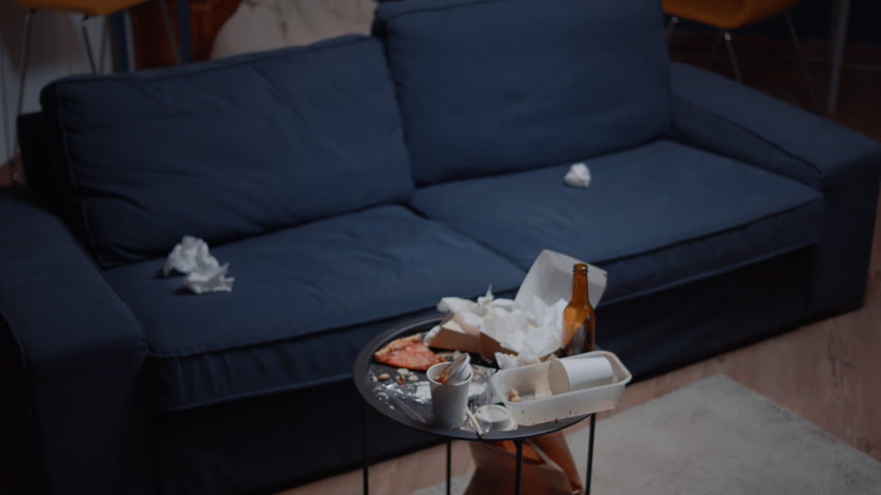 Close up of messy table with leftover in empty unorganized living room