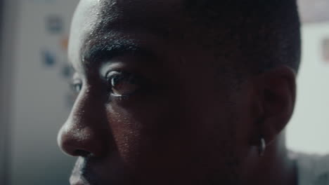 close-up of pensive black man at home