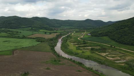 Aerial-sliding-footage-towards-the-right-of-this-Farmlands-and-Mountains-in-Muak-Klek,-Thailand