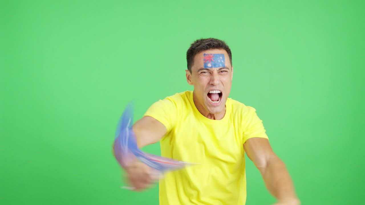 Man cheering for Australia screaming and waving a national flag