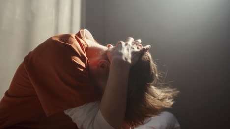 sad female inmate emotionally crying in solitary prison cell