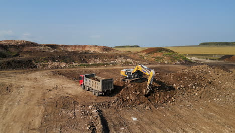 excavator loading dump truck in a quarry