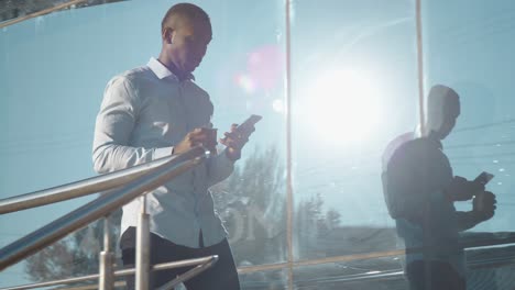 businessman using phone while walking outside
