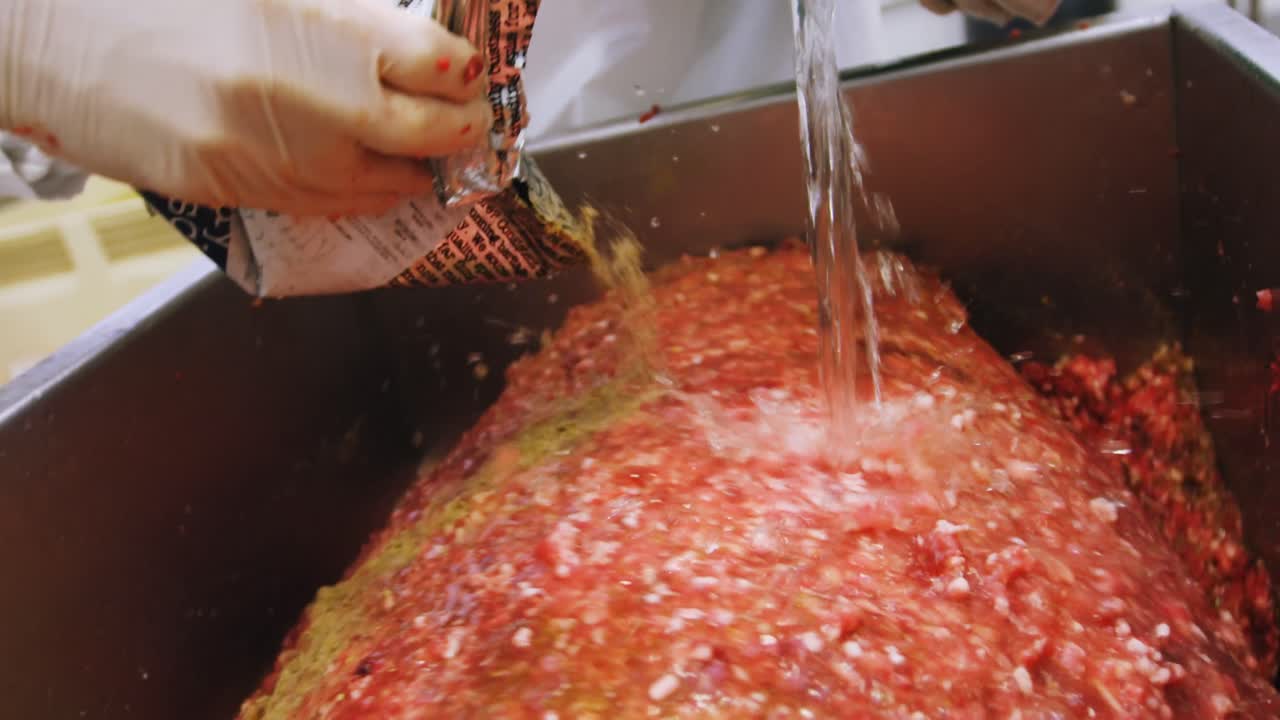 Butchers preparing minced meat