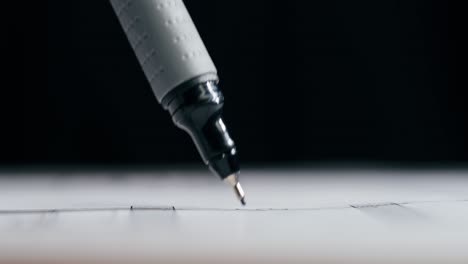 close-up of marker drawing a line on paper