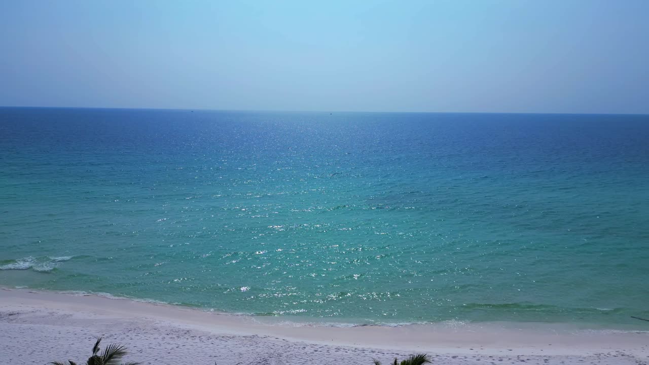 Sok San Beach with turquoise water washing the white sand, surrounded by palm trees and tropical vegetation. Unbelievable aerial view flight overflight flyover drone