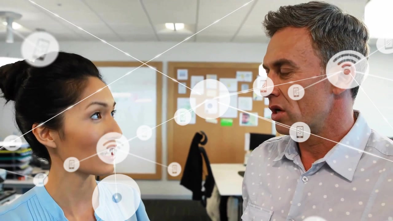 Animation of connected wifi and phone icons over colleagues discussing in office