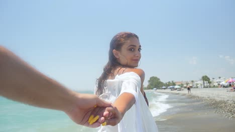 Follow-me,-point-of-view-of-a-beautiful-woman-in-white-holding-hands-and-leading-you-down-a-tropical-beach