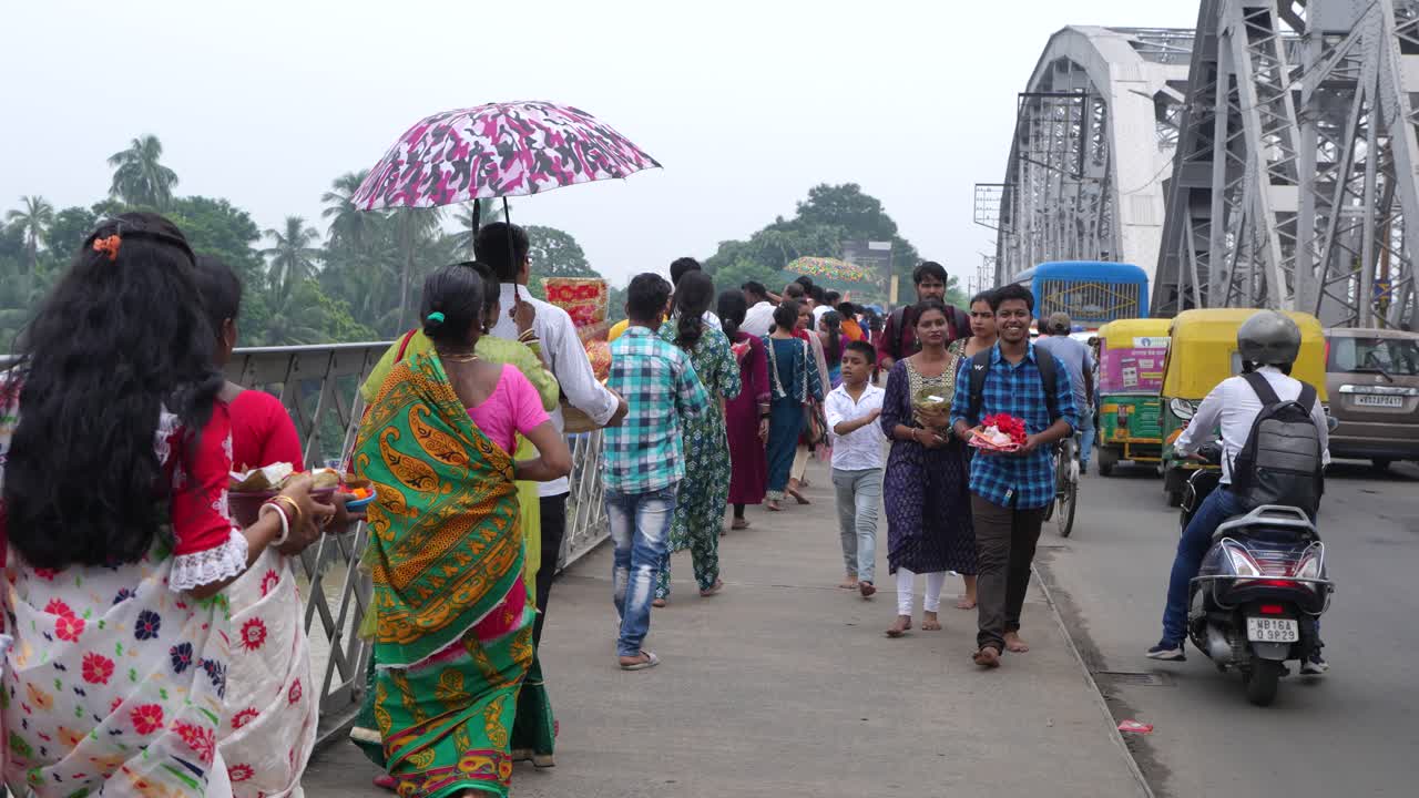 Crowds of People Walking on a Bridge in India