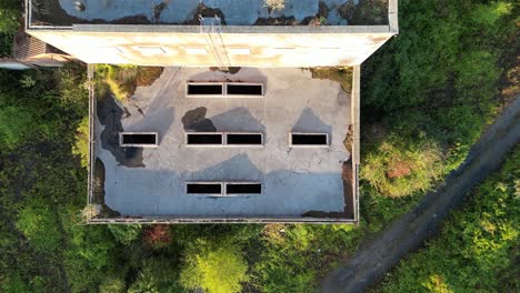 slow birds-eye-view of a disused coal mining building