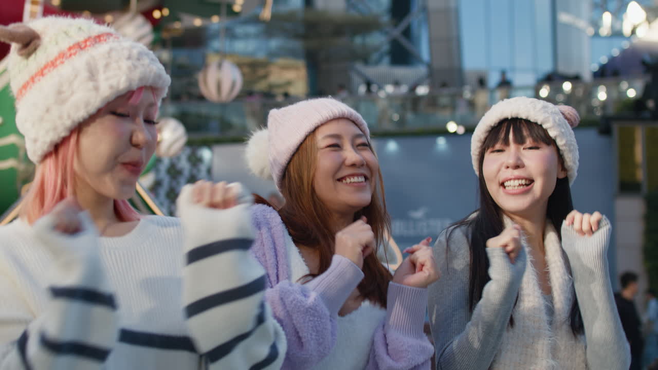 Three women in winter hats and sweaters