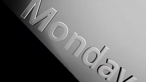 close-up of the word "monday" on a metallic surface