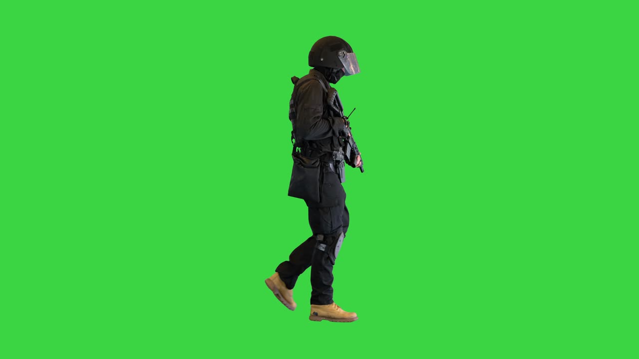 Swat operator with assault rifle walking on a Green Screen, Chroma Key