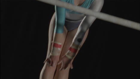 a female gymnast performs on parallel bars