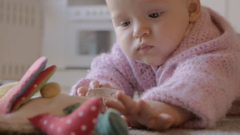 Caucasian-baby-girl-playing-on-the-carpet