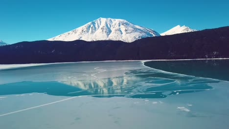 4k drone video of snow covered lakeside mountains in alaska