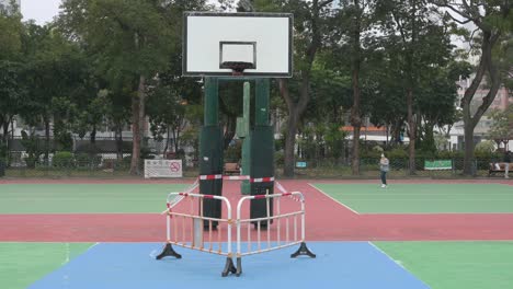 an empty colorful basketball court is seen at a closed playground due to covid-19 coronavirus outbreak and restrictions in hong kong