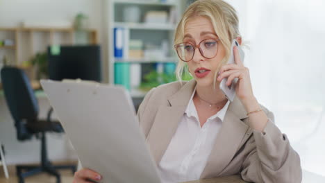 office secretary talks on phone and analyzes documents