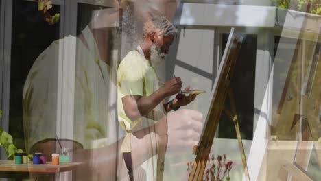 animation of senior african american man painting on easel in garden
