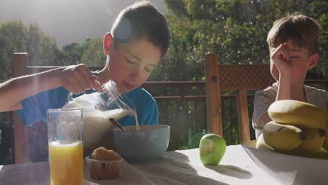 Family-eating-breakfast-together-outdoors