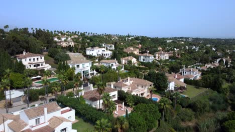 drone shot flying over houses in beautiful spanish countryside in summer